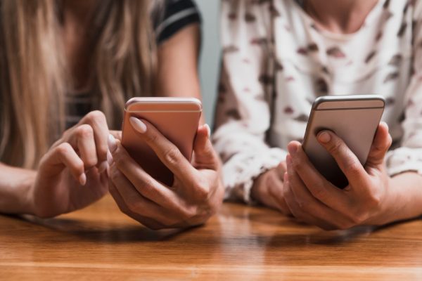 front-view-hands-typing-messages-phones